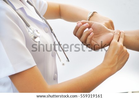 nurse is checking patience\'s pulse, medical checking on white back ground. Asian nurse.