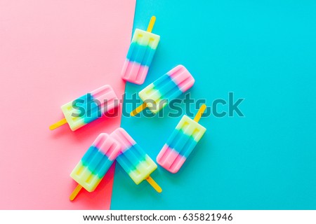 Fruit popsicle / ice cream on blue and pink background / Soda and Strawberry and Lemon popsicle / ice cream stick on blue and pink background