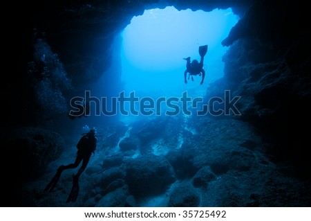 divers in underwater cave