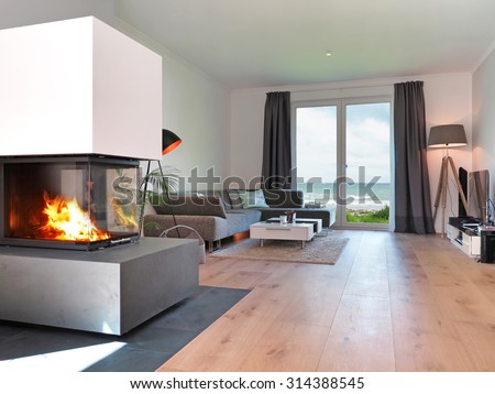 modern living room with fireplace and a view to the sea