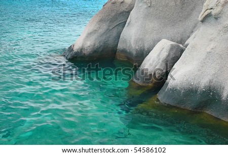 Water spilling over the rocks on the coast - Thailand