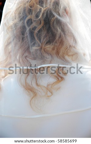 Head covered with a white bride\'s veil