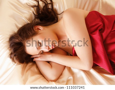 A beautiful woman lying in bed, top view