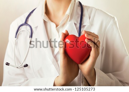 Female Doctor With Stethoscope Holding Heart, Isolated On White Background