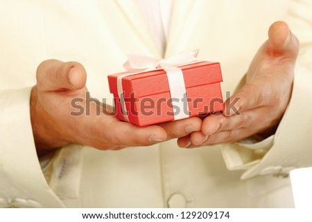 Unknown business man offering a gift