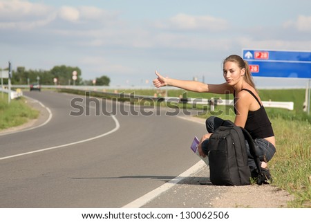 woman in the road auto-stop under the blue sky