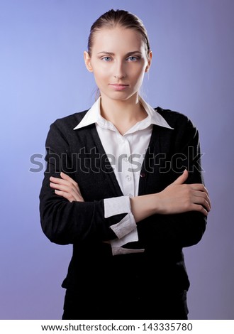 Portrait of beautiful business woman standing with folded arms, isolated on grey background