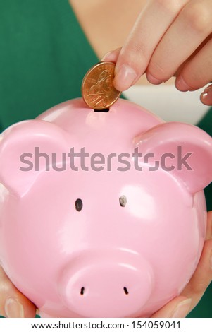 Unknown woman holding piggy bank (money box), isolated on white background