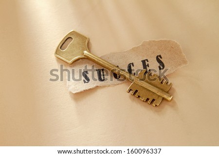 A word written on a ripped piece of paper and key