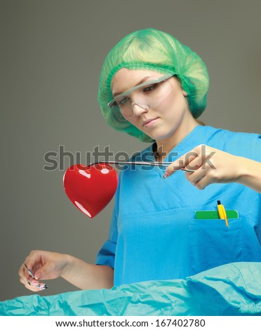 Female surgeon performing an operation on a heart patient