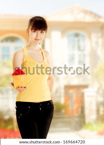 Young woman with little house