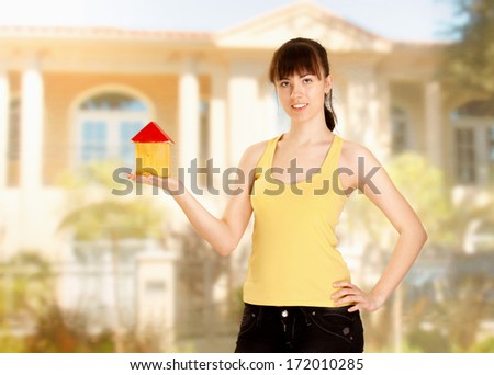 Young woman with little house