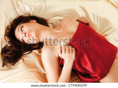 A beautiful woman lying in bed, top view