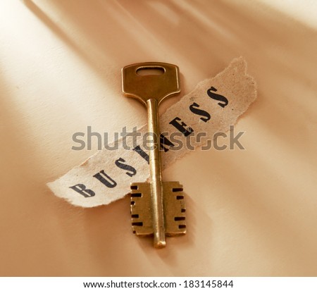 A word written on a ripped piece of paper and key