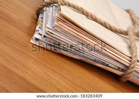 A newspaper stack isolated on wood background