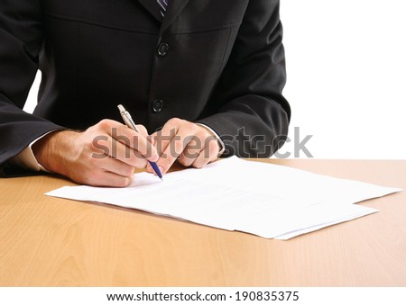 Unknown businessman sitting on the desk with documents