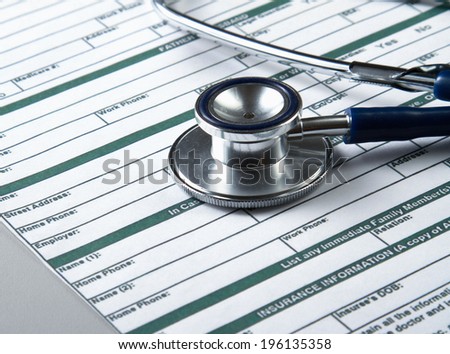 Stethoscope on medical billing statement on table, all text is anonymous