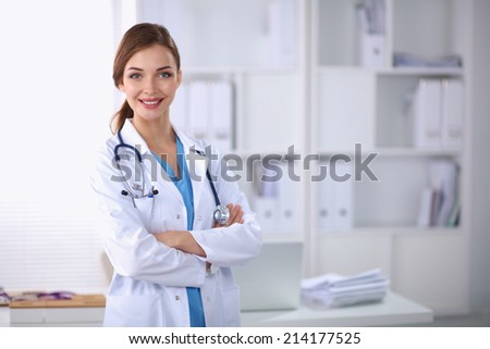 Portrait of young woman doctor with white coat standing in hosp