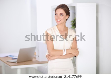 Close-up portrait of a smiling  business woman standing in her