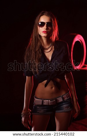 Portrait of young woman standing in the old garage. isolated on black background
