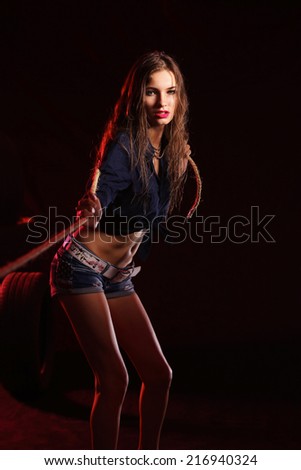 Portrait of young woman standing in the old garage. isolated on