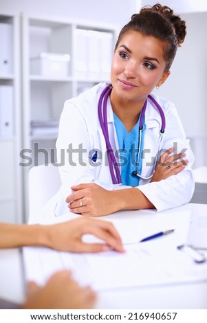 Doctor and patient sitting on the desk  at office