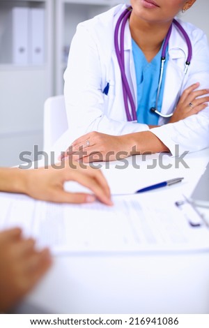 Doctor and patient sitting on the desk  at office