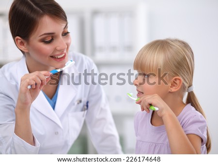 Dentist and little girl in the dentist office.isolated