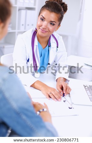 Doctor and patient sitting on the desk  at office, isolated