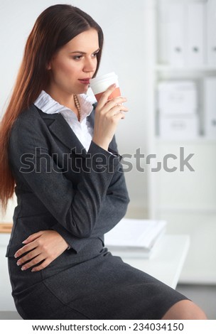 Woman drink coffee at office, standing near desk, isoalted