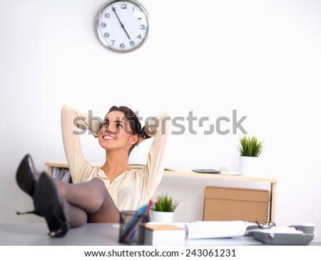 Business woman  relaxing with her hands behind her head and sitting on a chair