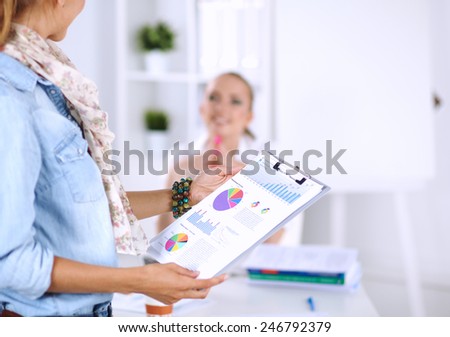 Close-up of businesswoman holding folder in hands