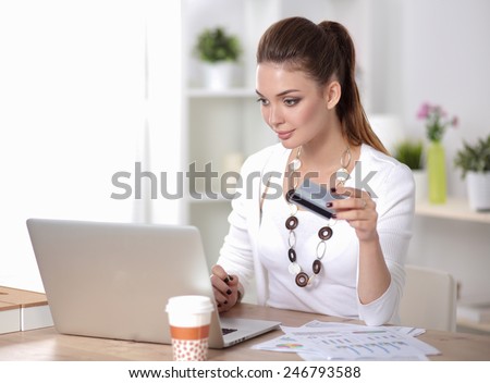 Businesswoman doing online shopping through laptop and credit card