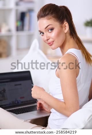 Woman shopping online with credit card and computer.Internet Shopping.