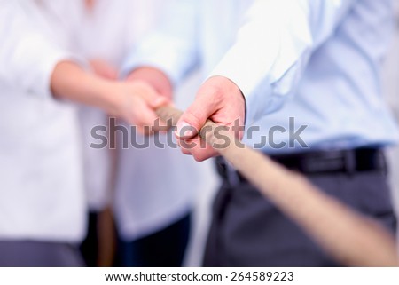Concept image of business team using a rope as an element of the teamwork