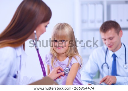 Female doctor examining child with stethoscope at surgery,isolated