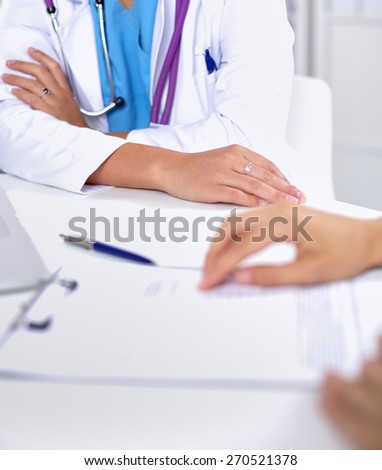 Doctor and patient sitting on the desk  at office .