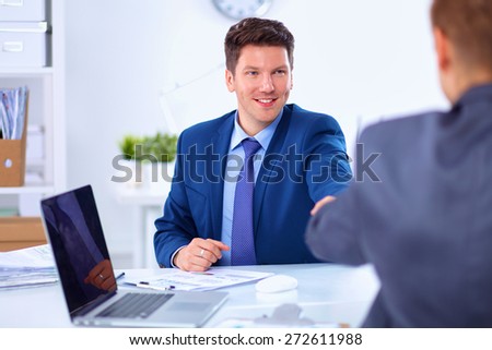 Business people working with laptop in an office, sitting ta the desk