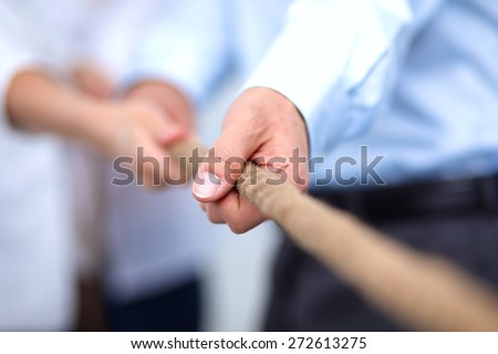 Concept image of business team using a rope as an element of the teamwork