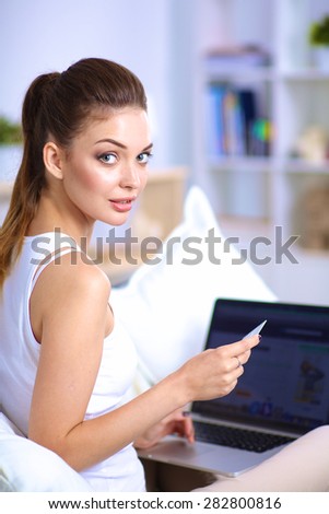 Woman shopping online with credit card and computer.Internet Shopping.