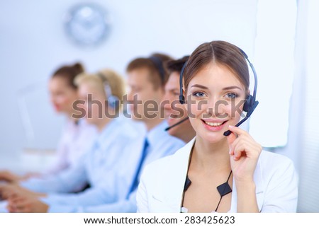 Attractive positive young businesspeople and colleagues in a call center office.