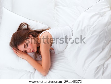 Beautiful girl lying in bedroom at early morning .