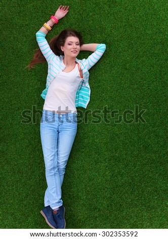 Top view of beautiful young woman holding hands behind head.