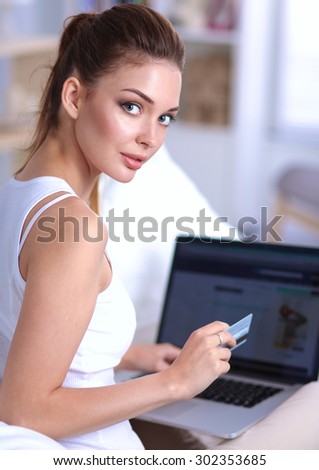 Woman shopping online with credit card and computer.Internet Shopping