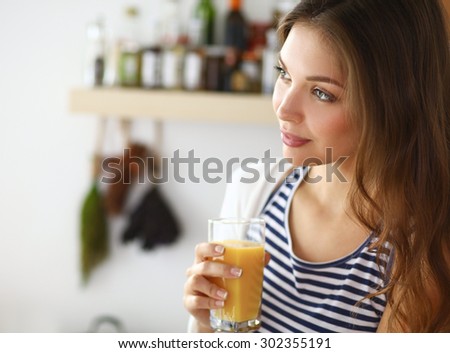 Portrait of a pretty woman holding glass with tasty juice .