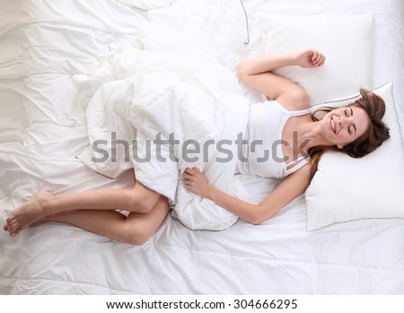 Beautiful girl lying in bedroom at early morning .