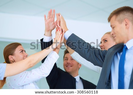 Business people with their hands together in a circle