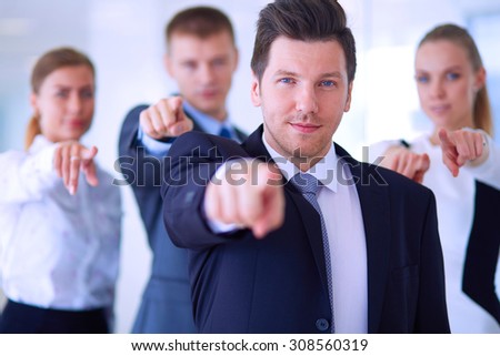 Group of business people pointing to you