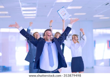 Business team celebrating a triumph with arms up