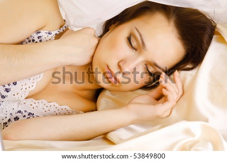Beautiful smiling woman on bed at bedroom